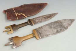 Two 19thC North African tribal knives with horn handles and brass or steel finials, longest 39cm