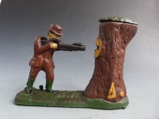 Novelty cast iron mechical money bank with a figure shooting the coin into a tree with pop-up