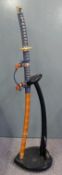 Japanese Samurai sword with gilt fittings and blue rope binding, overall 105cm on display stand