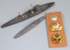 Three Russian badges together with two Royal Navy models of ships