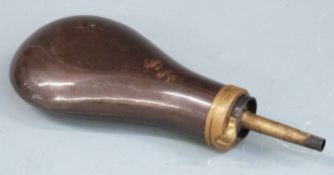 Copper and brass powder flask with embossed decoration to one side, 20cm long.