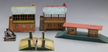 Five Hornby and similar 0 gauge model railway buildings and accessories comprising two signal boxes,
