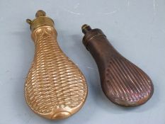 Two copper and brass powder flasks both with embossed decoration to each side, largest 20.5cm long.