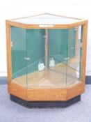 An early 20thC glazed oak haberdashery/shop fitting display cabinet with canted corners to suit