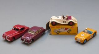 Four Dinky Toys diecast model cars comprising MG Midget Sports with white body, red interior and