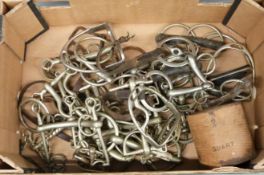 Collection of horse bits and stirrups together with a quart measure