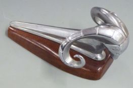 Dodge ram 1950's car mascot or hood ornament, on wooden display base, length 24cm