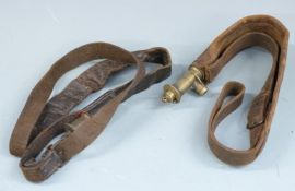 Two Bandolier type leather and brass shot flasks both with shoulder straps, largest 45cm long.