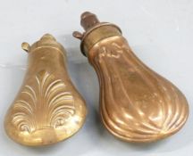 Two copper and brass pistol or revolver powder flasks both with embossed decoration to both sides,