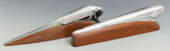 Two Pontiac car mascots or hood ornaments formed as stylised heads pushing through the air, length