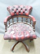A vintage red leather Chesterfield captain's or office swivel chair