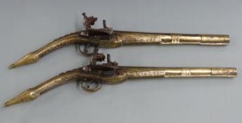 Pair of Albanian brass flintlock rat tail miquelet pistols each with all over engraving, studded