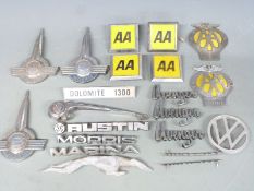 Collection of motoring badges including Morris, Dolomite 1300, American aluminium Greyhound bus,