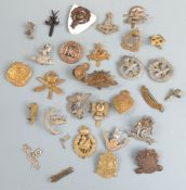 A small collection of cap badges including Lancashire Volunteers, Glider Pilot Regiment,