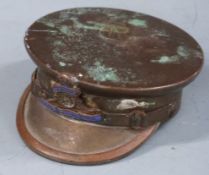 A brass trench art officer's cap with Royal Artillery motif, diameter 5cm