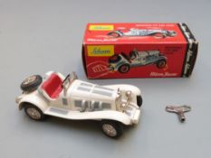 Schuco Micro Racer clockwork diecast model Mercedes Typ SSK (1928) with white body, red seat, and