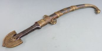A 19thC North African Moroccan tribal jambiya in brass and copper sheath, L44cm