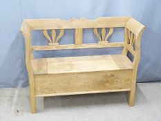A contemporary pine settle with hinged seat, W120 D42 H91cm