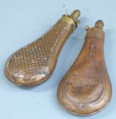 Two copper and brass powder flasks, one Dixon & Sons, both with embossed decoration to each side,