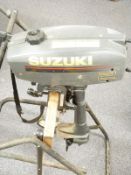 Suzuki 2 Horsepower outboard motor boat engine on wheeled stand