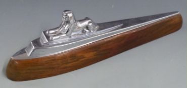 Armstrong Siddeley seated sphinx car mascot on wooden display base, length 35cm