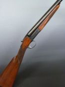 SKB Model 100 12 bore side by side shotgun with engraved lock, trigger guard, underside and top