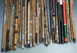 A collection of fishing rods, holdalls, landing net handles etc, including vintage cane rods,
