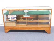 An early/mid 20thC glazed oak haberdashery/shop fitting display cabinet with interior waterfall