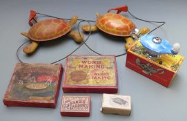 A small collection of children's toys and games comprising two Mobo metal pull-along Toy-toise,