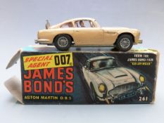 Corgi Toys diecast model James Bond 007 Aston Martin DB5 with gold body, red interior, spoked hubs