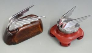 Two Wolseley car mascots, one on radiator cap, both on wooden bases, overall length of larger 13cm