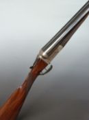 Thomas Wild 12 bore side by side ejector shotgun with engraved scene of dogs to the lock, engraved