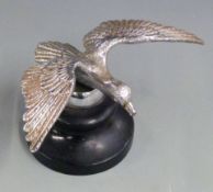 Vintage car mascot formed as a bird in flight, the base marked Desmo, on ebonised base, wingspan