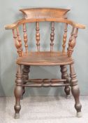 A 19th/20thC elm-seated armchair raised on turned legs