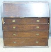A 19thC oak and pine bureau with fitted interior and four graduated drawers with brass campaign