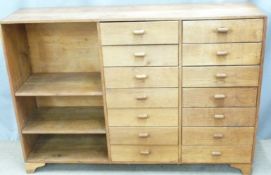 An oak shopfitting/haberdashery counter with fourteen drawers and shelves, W131 D35 H92