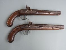 A pair of percussion hammer action holster pistols with engraved locks, hammers, top straps and