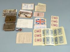 Two tins of 'Emergency Flying Ration MKII' with ministry marks, a quantity of uncut petrol coupons