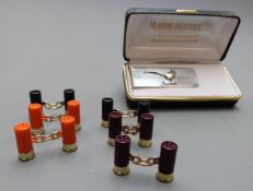 Three pairs of shotgun cartridge cufflinks and a money clip with pheasant decoration