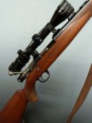 Husqvarna .243WIN bolt-action rifle with chequered semi-pistol grip, raised cheek piece, leather