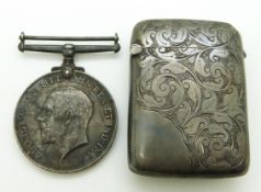 A hallmarked silver vesta case with scrolling foliate decoration and a WWI war medal named to 1335