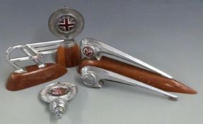 Two RAC car mascots, one on wooden display base, two Morris Minor mascots or bonnet handles and a