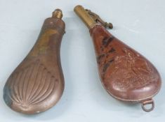 A copper and brass powder flask with embossed decoration to both sides together with a leather and