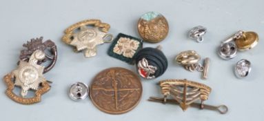 British Army cap badges and buttons with a Patrol Competition medal for the Duke of Cornwall's Light