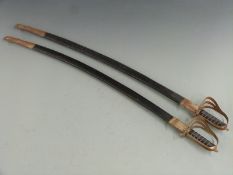 A pair of swords marked made in India with 78cm curved blades, both with scabbards