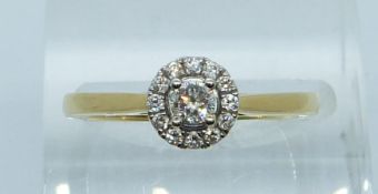 An 18ct white and yellow gold ring set with a diamond of approximately 0.14ct, with certificate