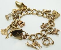 A 9ct gold curb link bracelet with twelve 9ct gold charms including golf bag, keys, deer, goat,