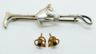 A pair of 9ct gold earrings set with a sapphire to each and a silver equestrian brooch