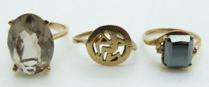 A 9ct gold ring set with quartz, a 9ct gold ring set with hematite and another 9ct gold ring, 9.9g