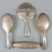 Hallmarked silver four piece dressing table set comprising hand mirror and three brushes